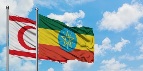 Northern Cyprus and Ethiopia flag waving in the wind against white cloudy blue sky together. Diplomacy concept, international relations.
