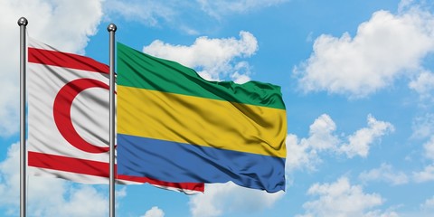 Northern Cyprus and Gabon flag waving in the wind against white cloudy blue sky together. Diplomacy concept, international relations.
