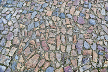 Old pavement of stones of different colors and sizes