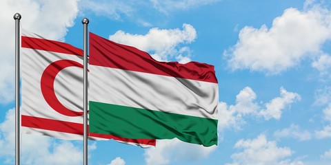 Northern Cyprus and Hungary flag waving in the wind against white cloudy blue sky together. Diplomacy concept, international relations.