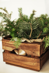  Wooden shabby rustic box filled with fir branches. The concept of decorating a Christmas tree and the New Year.