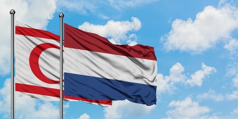 Northern Cyprus and Netherlands flag waving in the wind against white cloudy blue sky together. Diplomacy concept, international relations.