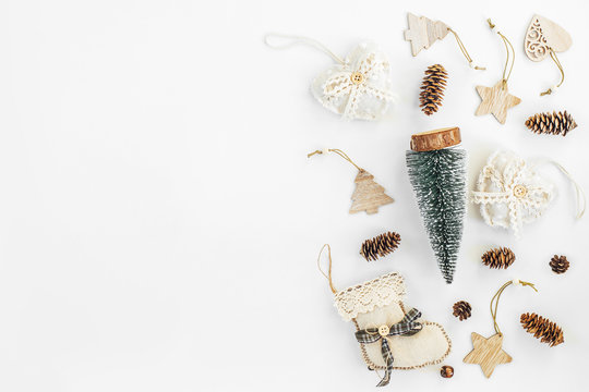Rustic Handmade Christmas decorations from natural materials  and garland on a white background with copy space. The concept of the new year, christmas and winter holidays.Flat lay, top view.