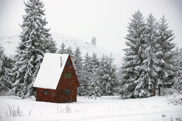 Snow covered hut in the mountains