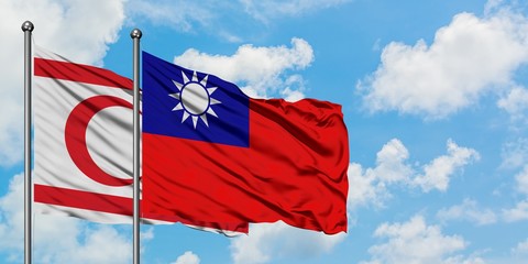 Northern Cyprus and Taiwan flag waving in the wind against white cloudy blue sky together. Diplomacy concept, international relations.