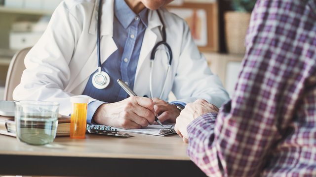 Doctor With Patient In Medical Office