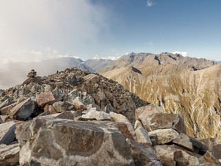 View from rocky mountain peak on stony slopes of Laub ridge; dangerous climbing and trekking route; gorge with steep walls between the arrays Laub and Candish; on mountain top