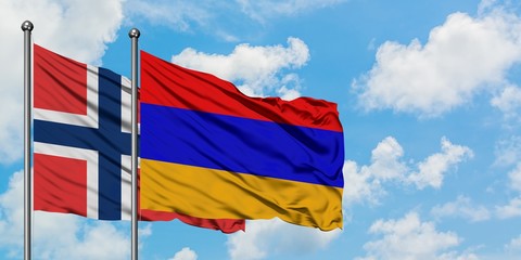Norway and Armenia flag waving in the wind against white cloudy blue sky together. Diplomacy concept, international relations.