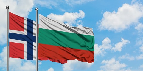 Norway and Bulgaria flag waving in the wind against white cloudy blue sky together. Diplomacy concept, international relations.