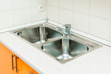 The photo of a sink in a The photo of a sink in a  kitchen