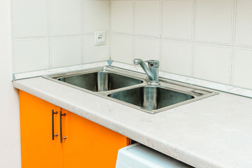 The photo of a sink in a The photo of a sink in a  kitchen