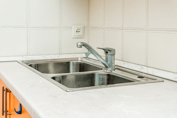 The photo of a sink in a The photo of a sink in a  kitchen