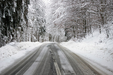 Empty road with snow banks on sides.