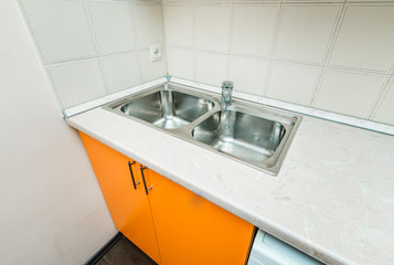 The photo of a sink in a The photo of a sink in a  kitchen