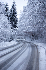Empty road with snow banks on sides.