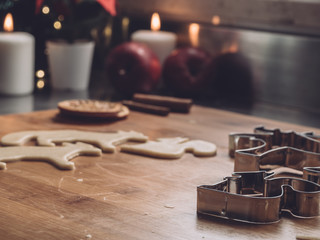 Christmas shapes on cookies dough. Home Pastry preparation on Christmas time. traditional christmas cookies with cinnamon and spice. candles and christmas trees on background 2