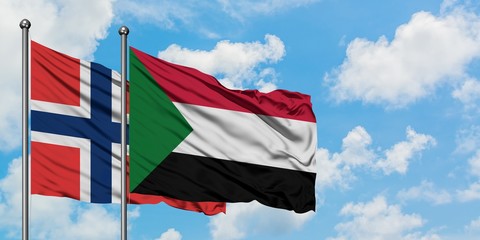 Norway and Sudan flag waving in the wind against white cloudy blue sky together. Diplomacy concept, international relations.