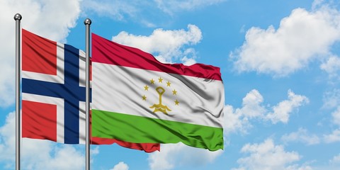 Norway and Tajikistan flag waving in the wind against white cloudy blue sky together. Diplomacy concept, international relations.