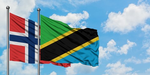 Norway and Tanzania flag waving in the wind against white cloudy blue sky together. Diplomacy concept, international relations.