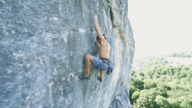 rock climber holds a carabiner on quickdraw, then let it off and falling. 120 fps slow motion