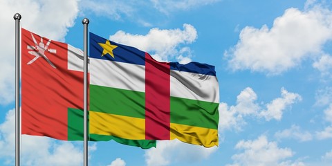 Oman and Central African Republic flag waving in the wind against white cloudy blue sky together. Diplomacy concept, international relations.