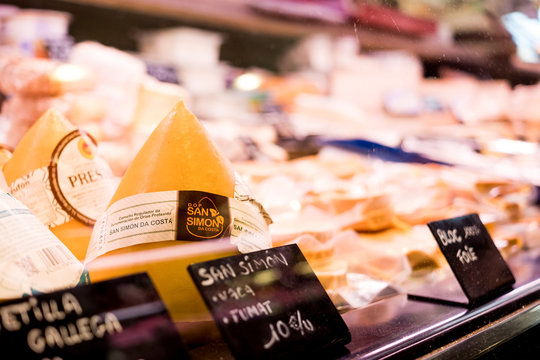 Barcelona, Spain - 10 december 2018: a piece of prestigious San Simon cheese sits in a shop among other delicacies. San Simon was elected best cheese of Spain in 2018