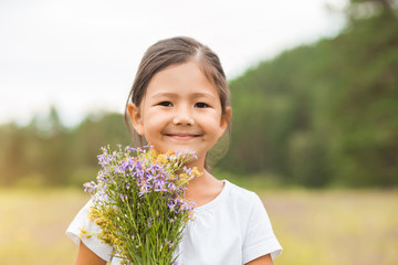 Portrait of a cute little girl outside