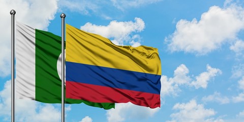 Pakistan and Colombia flag waving in the wind against white cloudy blue sky together. Diplomacy concept, international relations.