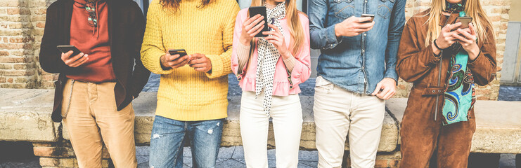 Group of friends watching smart mobile phones - Millennials addiction to new technology trends -...