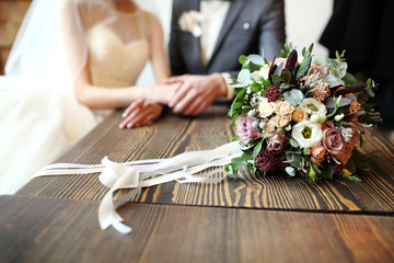 close up of wedding bouquet by wooden fence