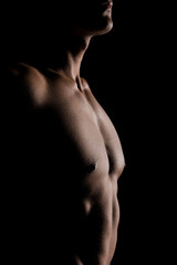 cropped view of shirtless man posing isolated on black
