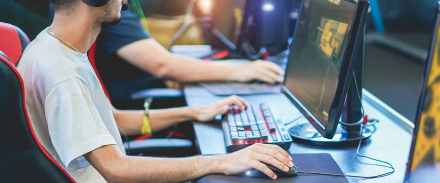 Young streamers gamers playing at e-sports competition - Male guys having fun gaming and streaming online - New technology game trends and entertainment concept - Focus on close-up hand