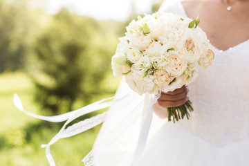 Bouquet in the hands of the bride close-up
