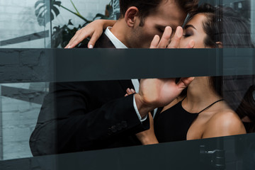 beautiful passionate couple hugging and kissing in lift
