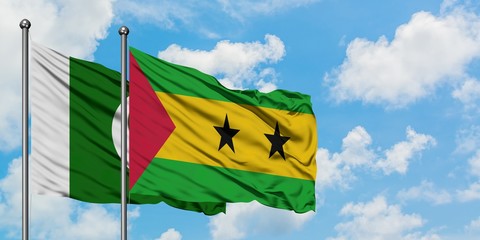 Pakistan and Sao Tome And Principe flag waving in the wind against white cloudy blue sky together....