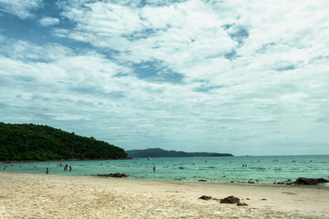 Beautiful turquoise sea, sky with clouds, white line beach, natural tourism concept