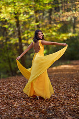 Beautiful woman dancing in the forest