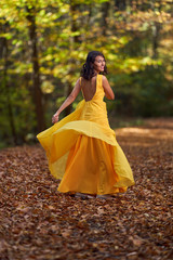 Beautiful woman dancing in the forest