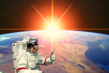 Astronaut and sunrise. The elements of this image furnished by NASA.