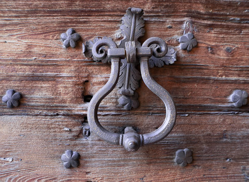 Iron Knocker On An Old Wooden Door