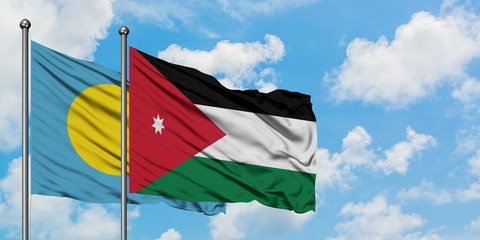 Palau and Jordan flag waving in the wind against white cloudy blue sky together. Diplomacy concept, international relations.