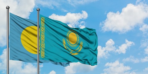 Palau and Kazakhstan flag waving in the wind against white cloudy blue sky together. Diplomacy concept, international relations.