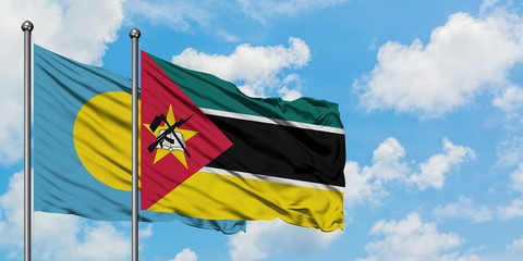 Palau and Mozambique flag waving in the wind against white cloudy blue sky together. Diplomacy concept, international relations.