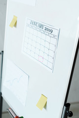 Naklejka na ściany i meble selective focus of calendar with january letters on flipboard