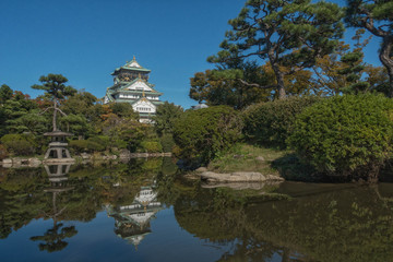 Obraz premium 大阪城の日本庭園の池に映る天守閣のリフレクションの風景