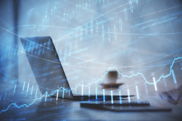 Double exposure of graph and financial info and work space with computer background. Concept of international online trading.