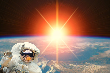 Astronaut and sunrise. The elements of this image furnished by NASA.