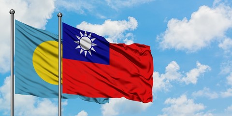 Palau and Taiwan flag waving in the wind against white cloudy blue sky together. Diplomacy concept, international relations.