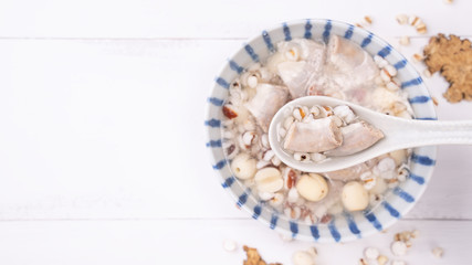 Tasty Four Tonics Herb Flavor Soup,Taiwanese traditional food with herbs,pork intestines on white wooden table,close up,flat lay,top view