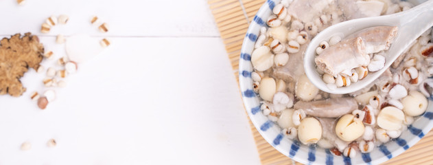 Tasty Four Tonics Herb Flavor Soup,Taiwanese traditional food with herbs,pork intestines on white wooden table,close up,flat lay,top view